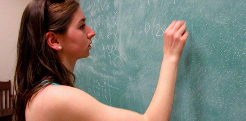 Molly Atwater writes on a chalkboard